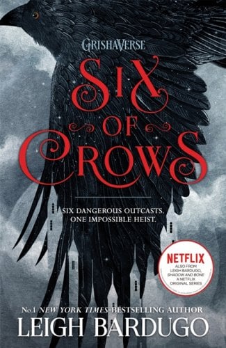 The book cover of Six of Crows by Leigh Bardugo. It has a photo of a crow in flight and it mentiones that it is in the Grishaverse and is a Netflix series (Shadow and Bone).